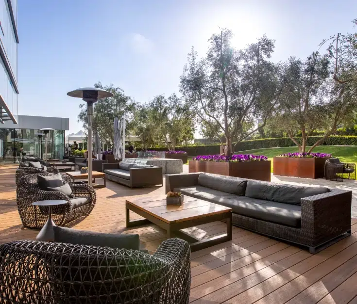 Outdoor patio with grass and couches on deck projects in Los Angeles