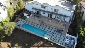 Timbertech deck and full backyard remodeling by LA Decks with pool, hardscaping, and grass