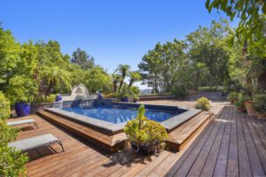 Luxurious poolside with decks in West Hollywood surrounded by palm trees