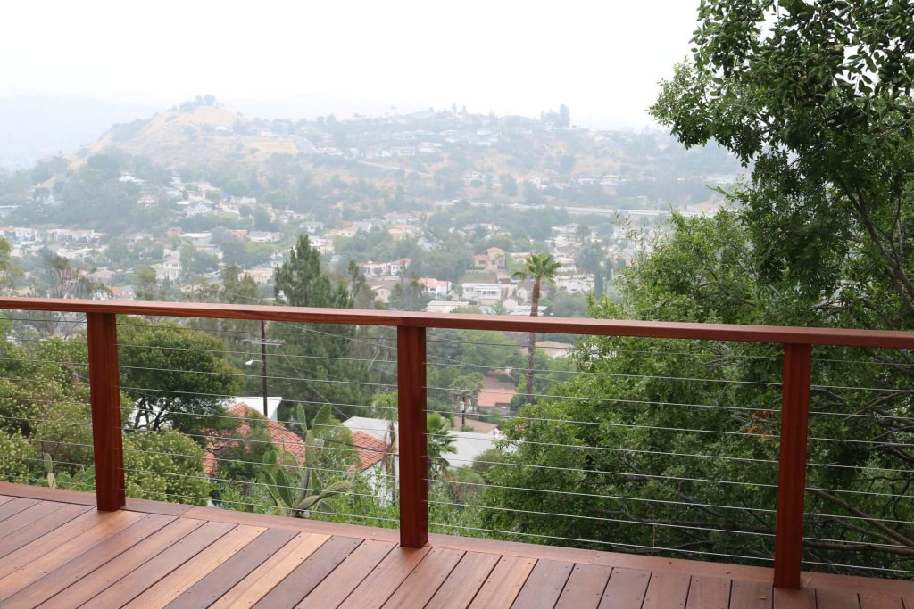 Wooden Deck Outlined By Steel Cable Railing