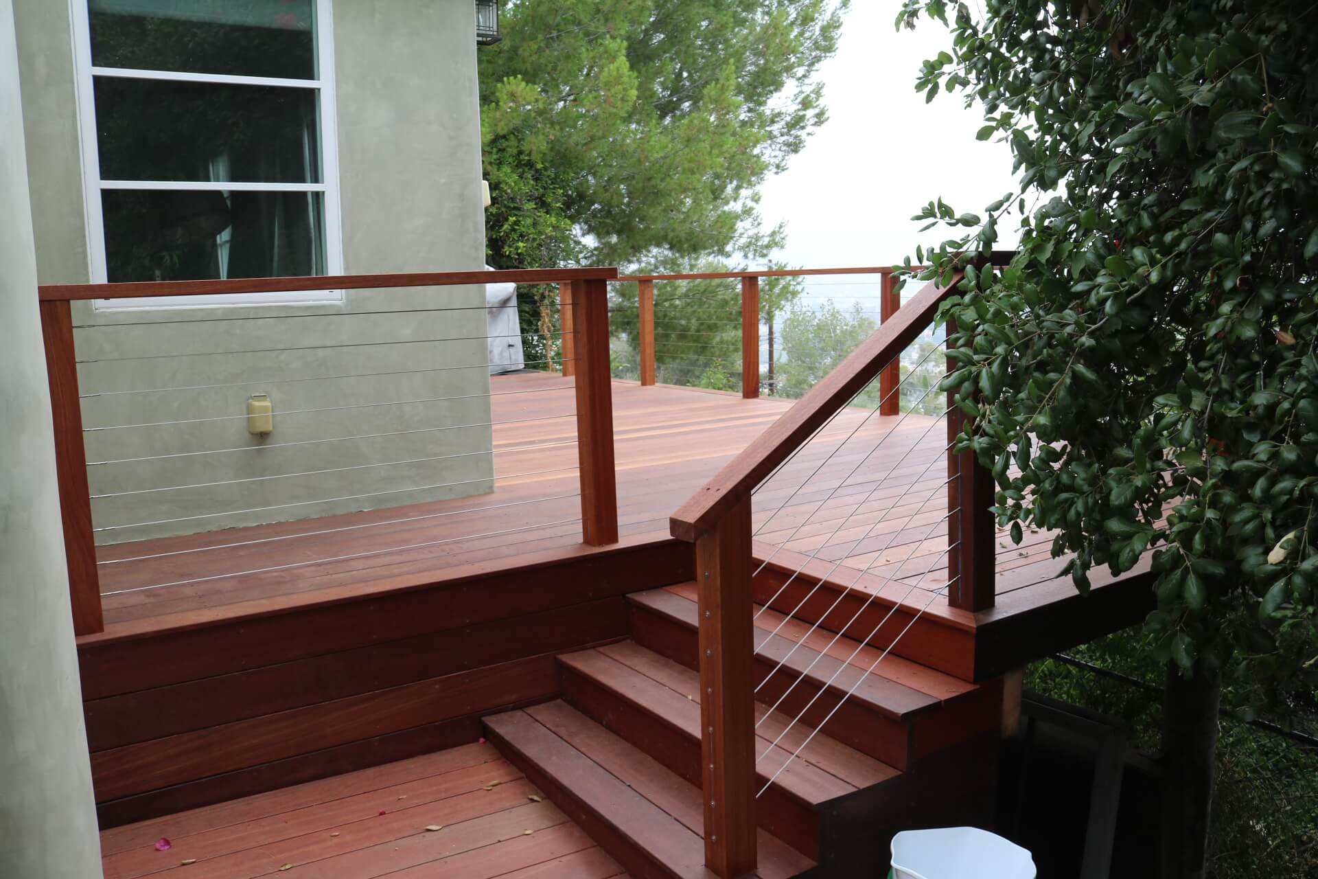 Dark Lumber Two-Story Deck with a Cable Railing Stairwell