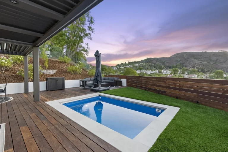 Professional cleaning and restoration of a modern poolside composite deck with a pergola in the Hollywood Hills by LA Decks.
